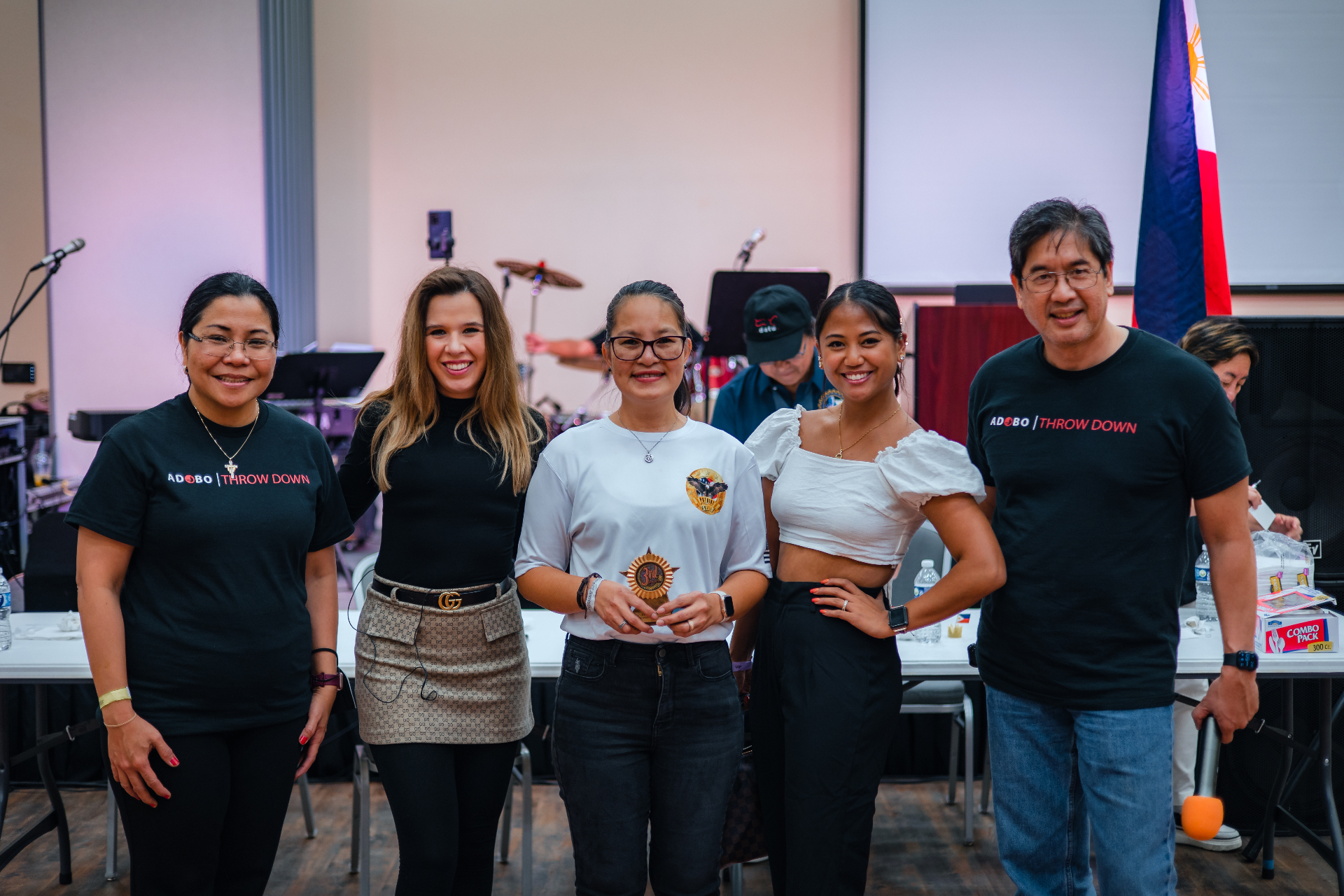 Ube Throwdown winner holding trophy with event organizers.